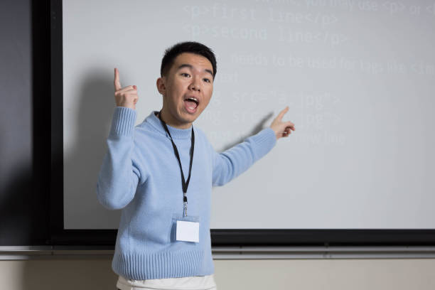 istock A man in a blue sweater is presenting in front of a whiteboard 2184217195
