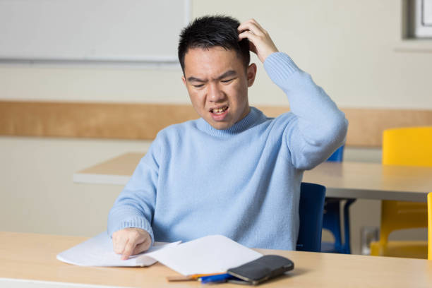 istock A young university student scratching his head in confusion during a test 2184217400