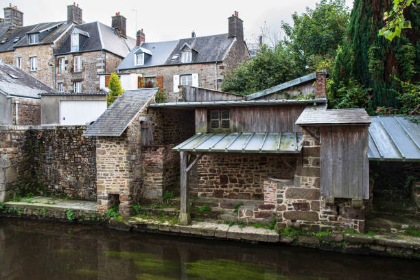 Old wash houses along the river Sienne in the town of Villedieu-Les-Poêles, Normandy, France