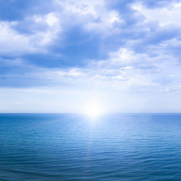 istock Calm windless ocean with the sun on the horizon. 2184218435