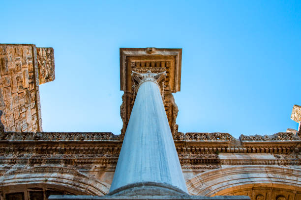 A stunning view of Hadrian's Gate, a well-preserved Roman triumphal arch in Antalya, Turkey. Built in honor of the Roman Emperor Hadrian, this historical monument showcases exquisite ancient architecture, with intricate carvings and columns that reflect the grandeur of the Roman Empire. The gate remains a symbol of Antalya's rich cultural heritage and its strategic significance during Roman rule. This captivating image is perfect for travel advertisements, promotions highlighting Turkey’s historic landmarks, or architectural showcases. Ideal for campaigns focusing on cultural tourism, heritage, and ancient architecture.