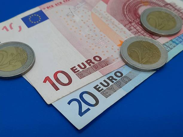 istock Euro coin and banknote 2184223179