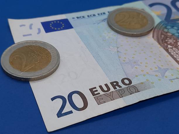 istock Euro coin and banknote 2184223197