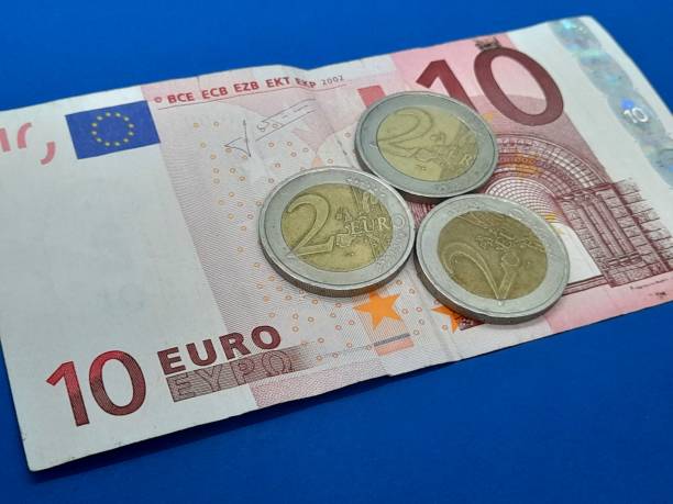 istock Euro coin and banknote 2184223235