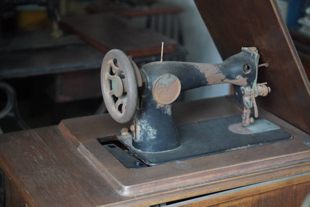 istock antique and dirty black and brown sewing machine on wooden sewing machine table, object, technology, work, decor, copy space 2184223271
