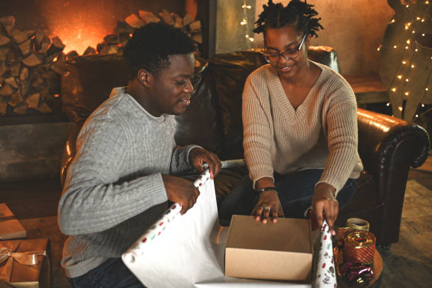 istock young couple wrapping christmas presents 2184223313