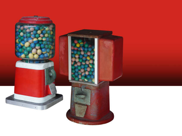 istock side view two antique red and white gumball machine on white floor, gradient red background, object, play, toy, decor, fashion, copy space 2184223345