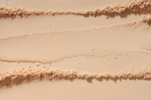 istock Cosmetic product beige pressed or loose powder texture swatch sample background 2184224454
