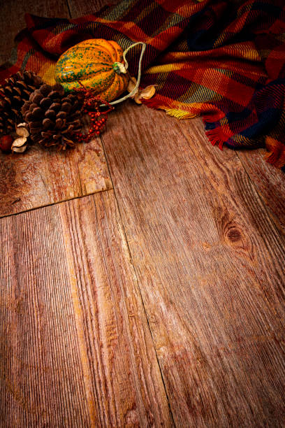 This is a close up photo of autumn decorations on a wood textured background. There is space for copy. This is a nice image that would work well for autumn, Thanksgiving and a holiday Halloween season in the fall.