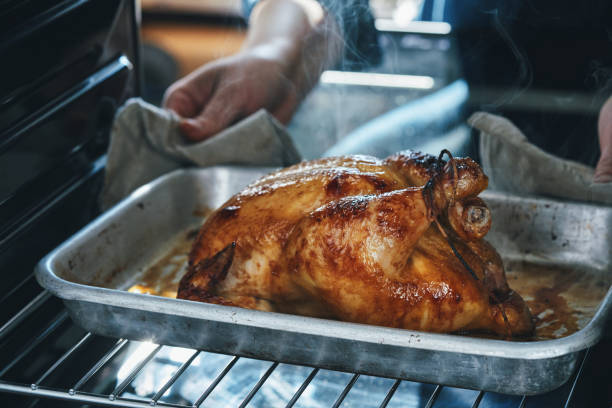 istock Preparing Roasted Chicken with Root Vegetables in Domestic Kitchen 2184224536