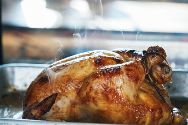 istock Preparing Roasted Chicken with Root Vegetables in Domestic Kitchen 2184224537