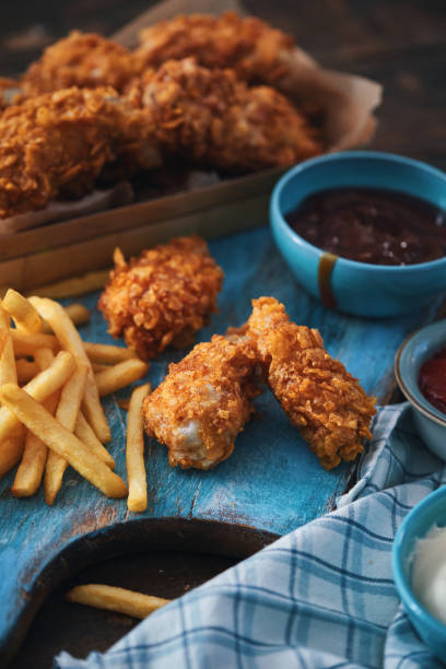istock Crispy Fried Chicken Drumsticks with French Fries 2184224635