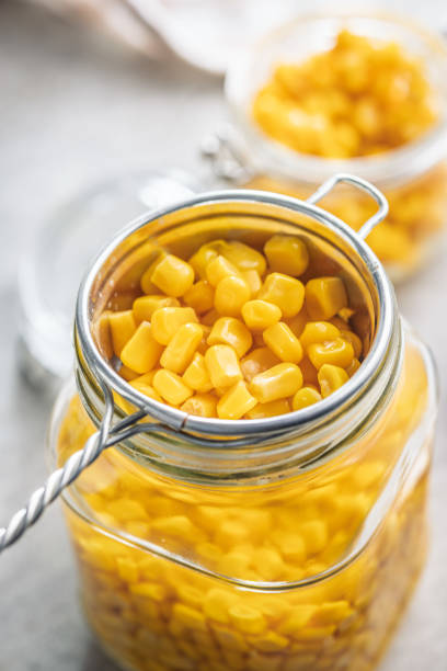 istock Canned sweet corn in colander on kitchen table. 2184224796