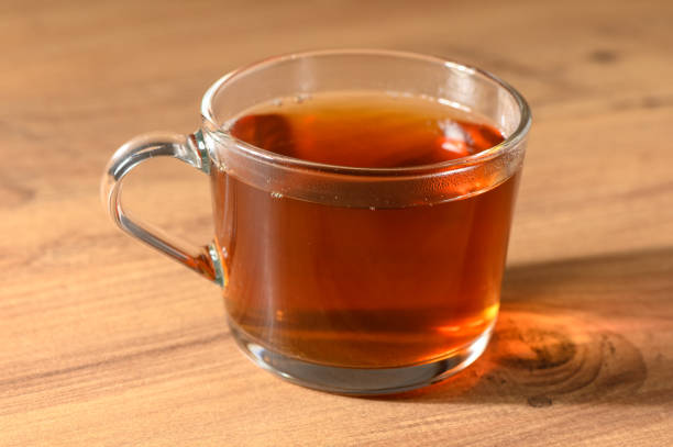 Red view of black tea in a half-view tea glass with handle