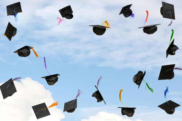 istock Graduation caps thrown in the sky 2184227175