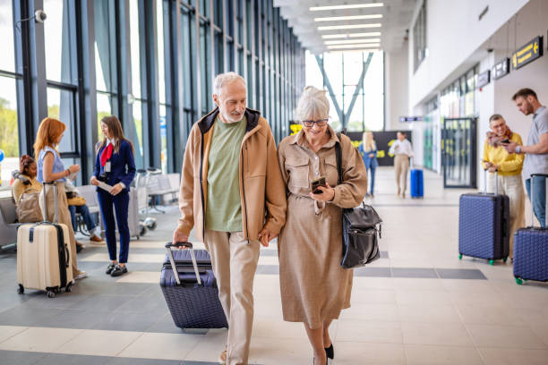 istock Elderly couple strolling through airport terminal. 2184229711