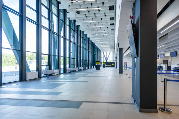 istock Empty airport corridor with seating and check-in desks 2184230904