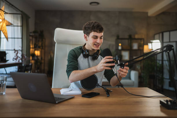 istock Young man blogger prepare equipment for new video at home studio 2184231840