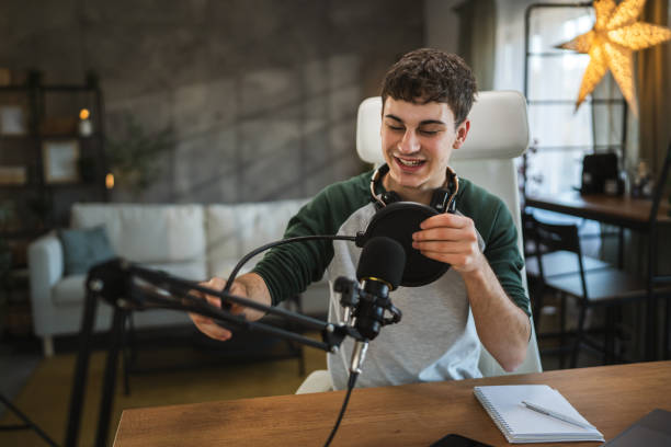 istock Young man blogger prepare equipment for new video at home studio 2184231841