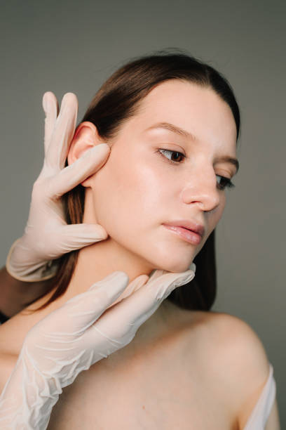 istock Correcting face treatment for aesthetic and beautiful shape. Female contour plastic. Correcting the shape of the skin face of young woman by beautician. 2184232317