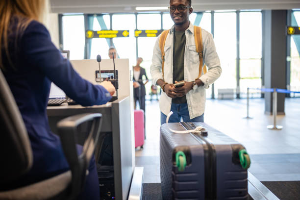istock Man steps back after check-in at airport counter. 2184234435
