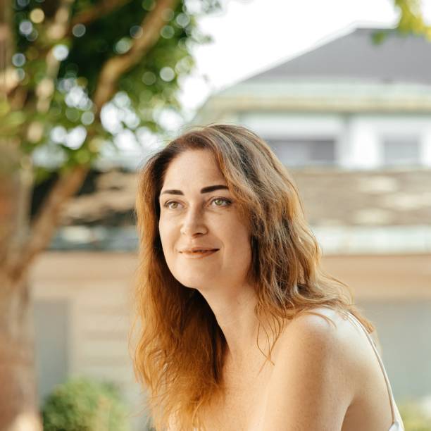 istock Woman in white dress relaxing by a window frame 2184234632
