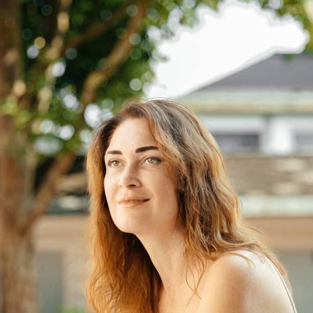 istock Woman in white dress relaxing by a window frame 2184234636