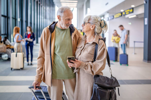 istock Older pair shares a moment amidst travel buzz. 2184235618