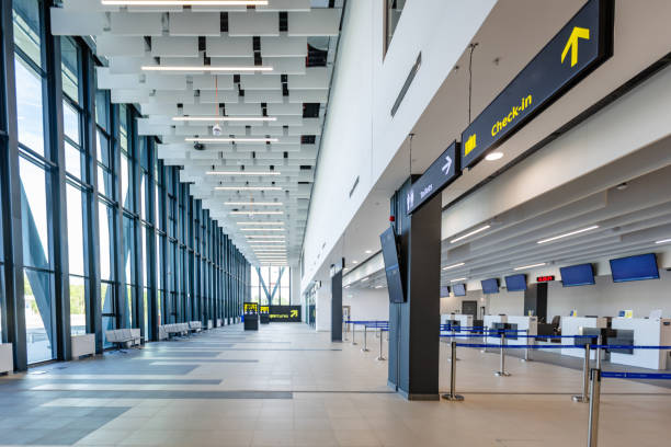 istock Open airport lobby with directional signs and check-in desks 2184235641