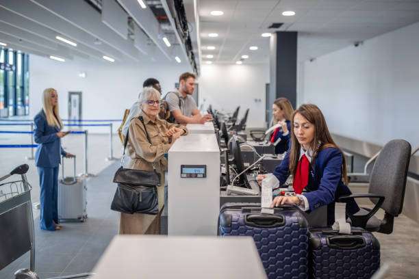 istock Passengers and staff at busy airport check-in counter 2184235808