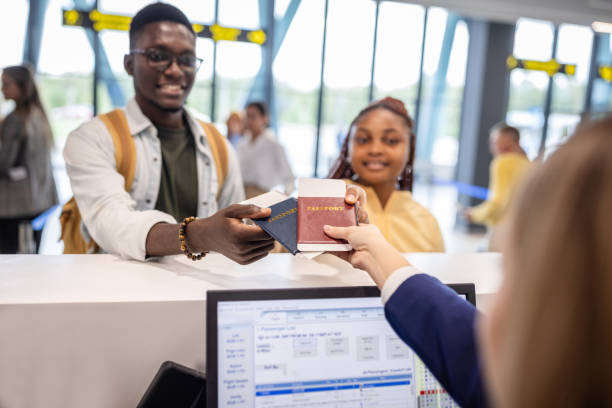istock Passengers checking in at modern airport counter desk 2184235815