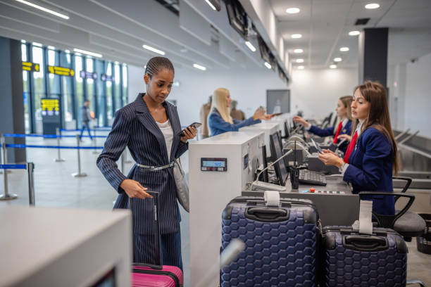 istock People at counter ready for departure, luggage waiting 2184236025