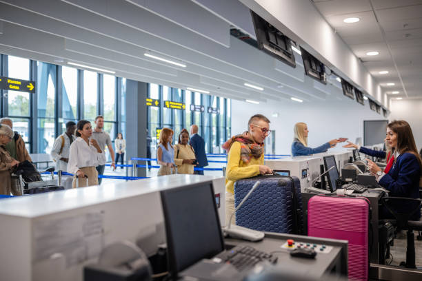 istock People waiting in line at check-in counters in airport 2184236100