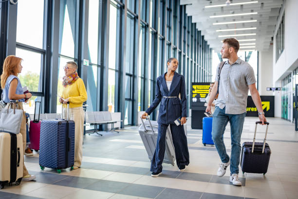istock Professionals in conversation at airport terminal 2184236805
