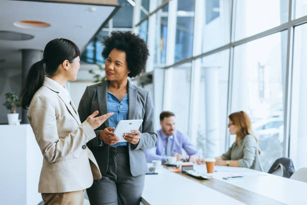 istock Two colleagues engage in business discussion 2184237547