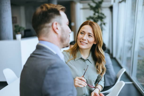 istock Professionals exchanging ideas in business meeting 2184237553