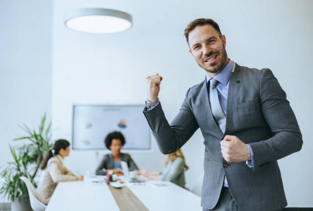 istock Happy businessman cheering in modern office 2184237579
