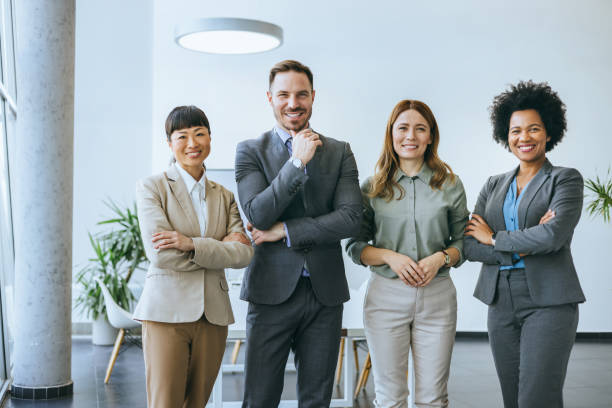 istock Business team posed in office with arms crossed 2184237591