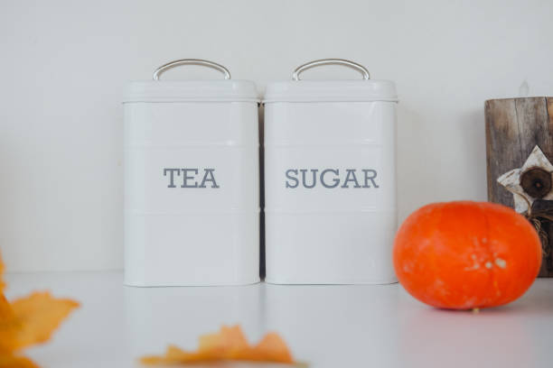 istock White containers labeled tea and sugar with autumn decor on a kitchen counter 2184238061