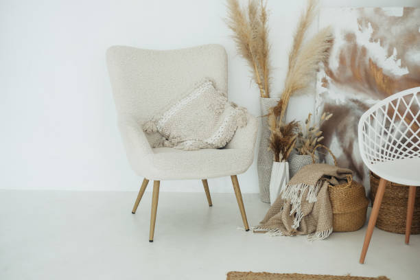 istock Cozy modern living space featuring armchair and decorative elements against a minimalist backdrop 2184238159