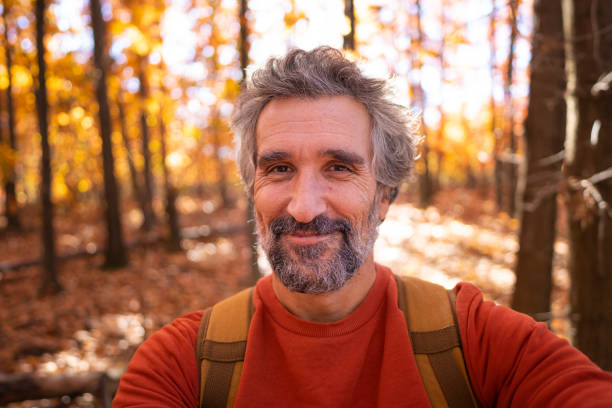 Smiling Mature Man Selfie In Bright Autumn Forest