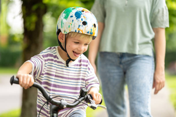 istock Young Boy Enjoys Bicycle Ride with Safety Helmet 2184238774