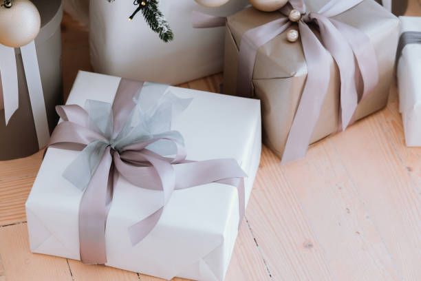 istock Beautifully wrapped gifts sit elegantly beneath a festive Christmas tree 2184239817