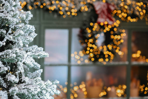 Cozy winter scene with a snow-covered tree and festive decorations at dusk