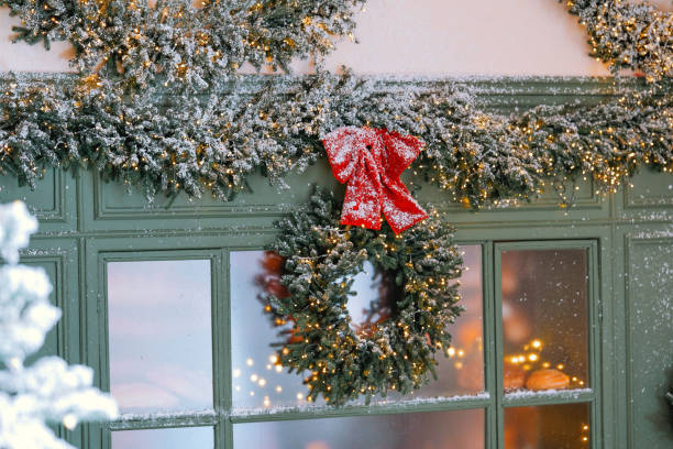 istock Cozy home's winter decor with a lit wreath and garland 2184239829