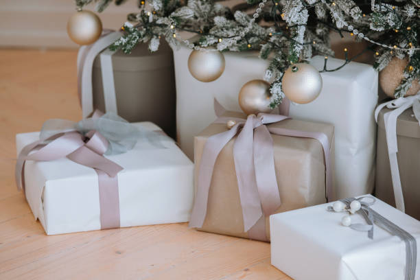 istock Wrapped holiday gifts beneath a beautifully decorated Christmas tree 2184239849