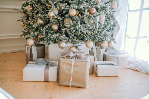 istock Festively wrapped gifts under a beautifully decorated Christmas tree 2184239867
