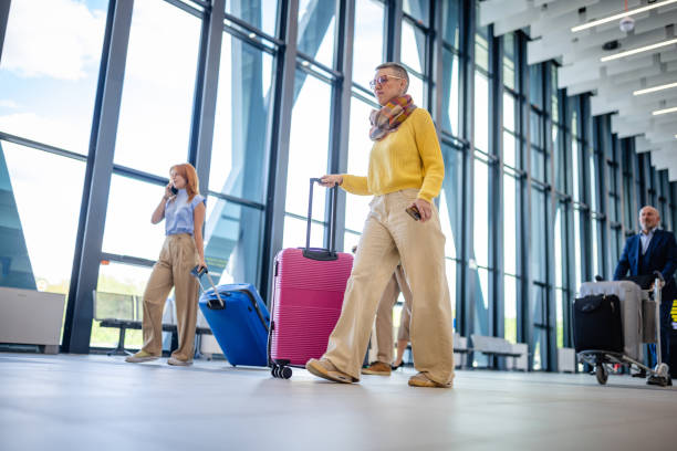 istock Stylish travelers in a spacious airport terminal 2184240401