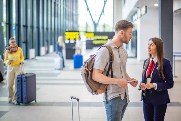 istock Traveler asking airport staff for flight information 2184240897