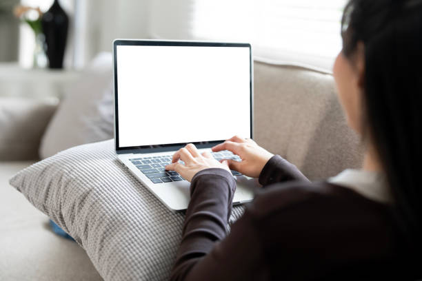 istock Woman using and typing on laptop with blank white screen. Mockup blank white desktop screen 2184241204